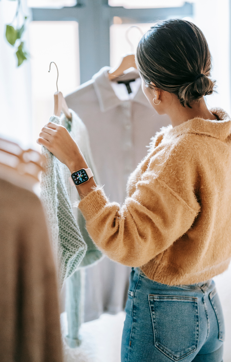 Boutique owner choosing clothing